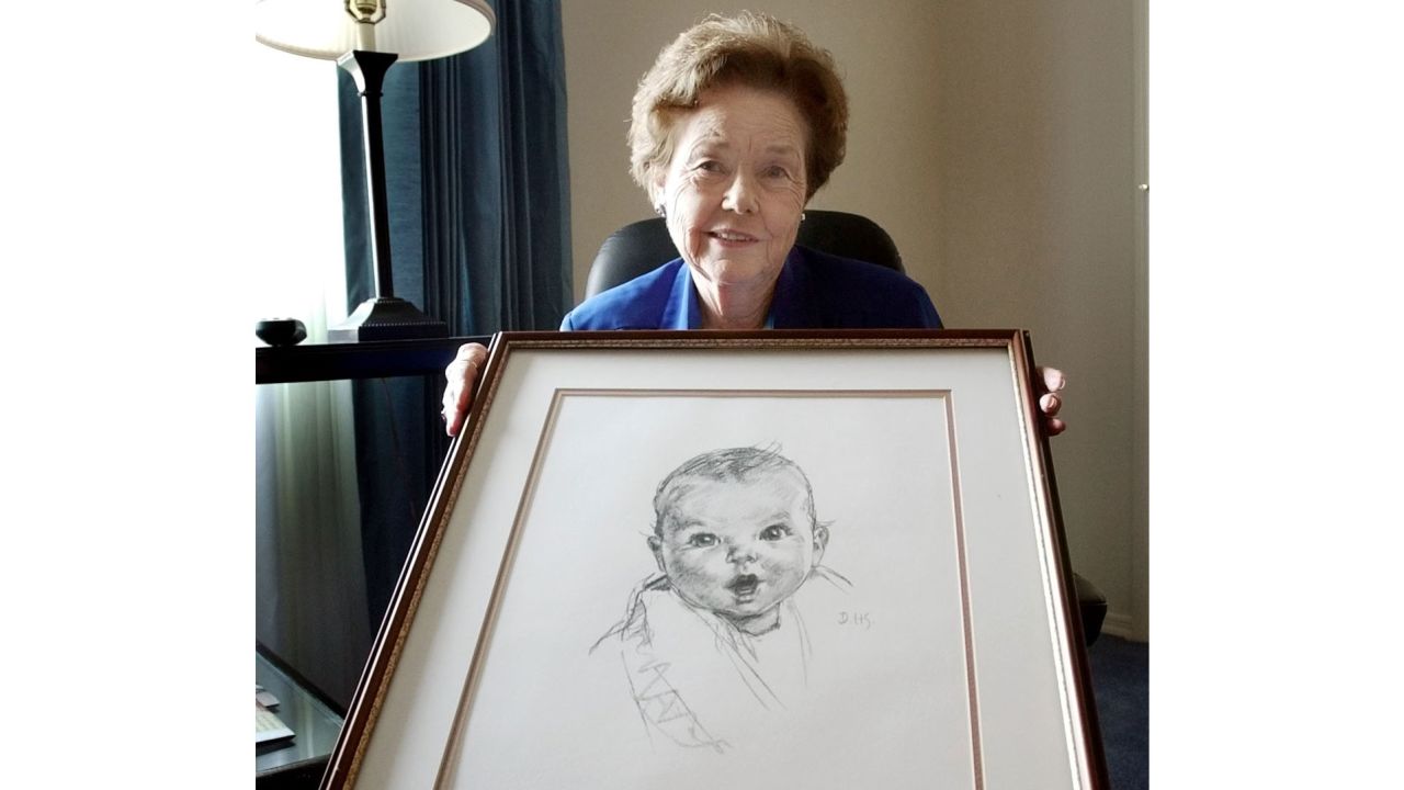 Ann Taylor Cook is shown in February 2004 with a copy of her photo that is used on all Gerber baby food products.