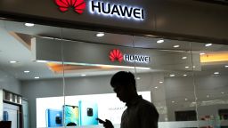 A man walks past a Huawei logo displayed at a retail store in Beijing, May 23, 3019.