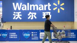 A customer walks past an entrance of a Walmart Inc. store in Xiamen, China, on Monday, Aug. 26 2019. U.S. companies are concerned about President Donald Trumps threats to ban them from doing business in China, and theyre poised to halt new investments if the trade war escalates, the leader of group of top chief executive officers said