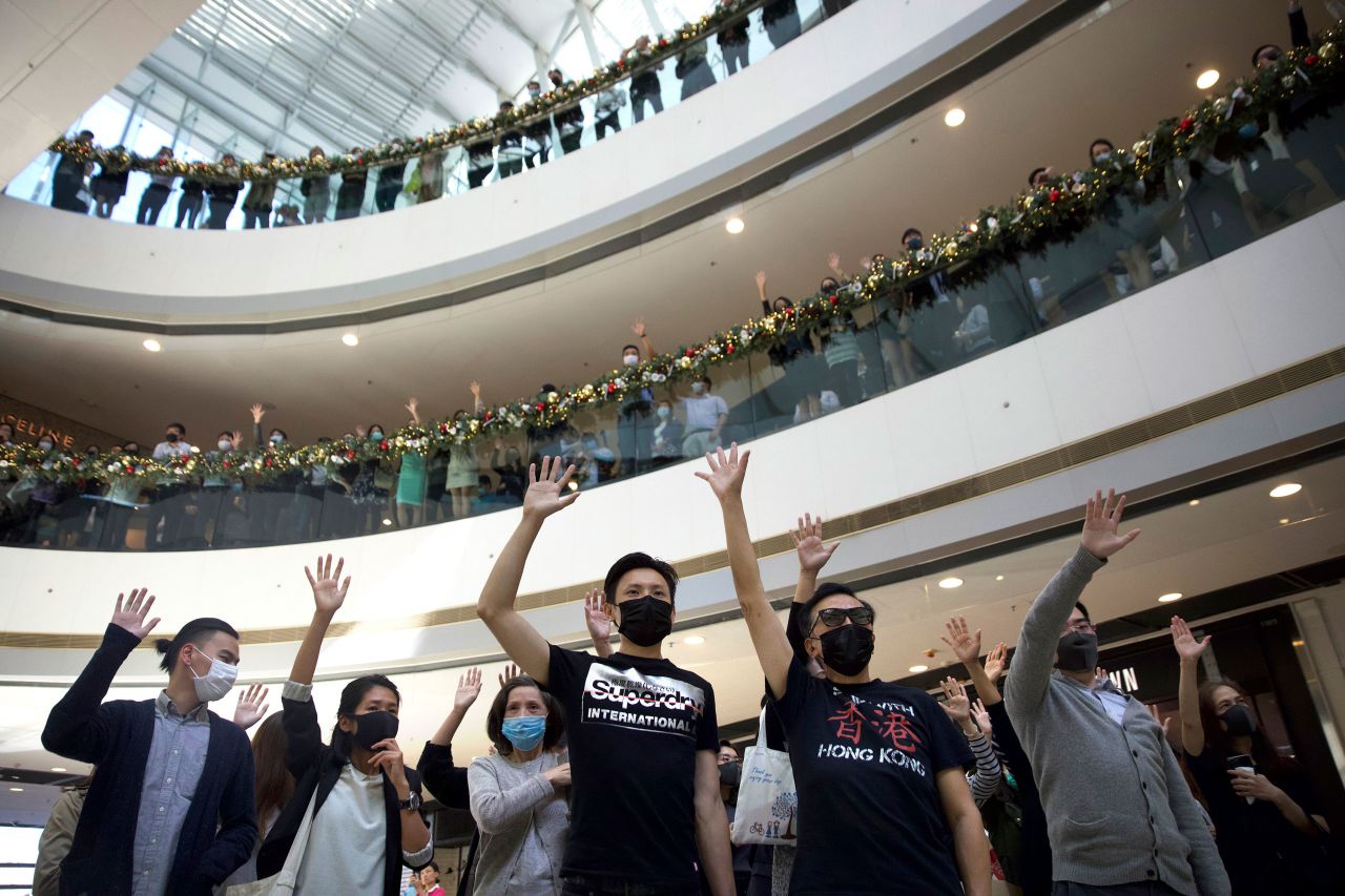 Protesters raise their hands to represent the five demands of pro-democracy demonstrators during a rally in support of the Hong Kong Human Rights and Democracy Act in the U.S., at the IFC Mall in Hong Kong, on November 21.