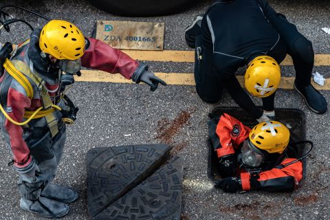 A Fire Services Department rescue diver prepares to enter the sewage system on November 20 to search for protesters who escaped from the Hong Kong Polytechnic University.