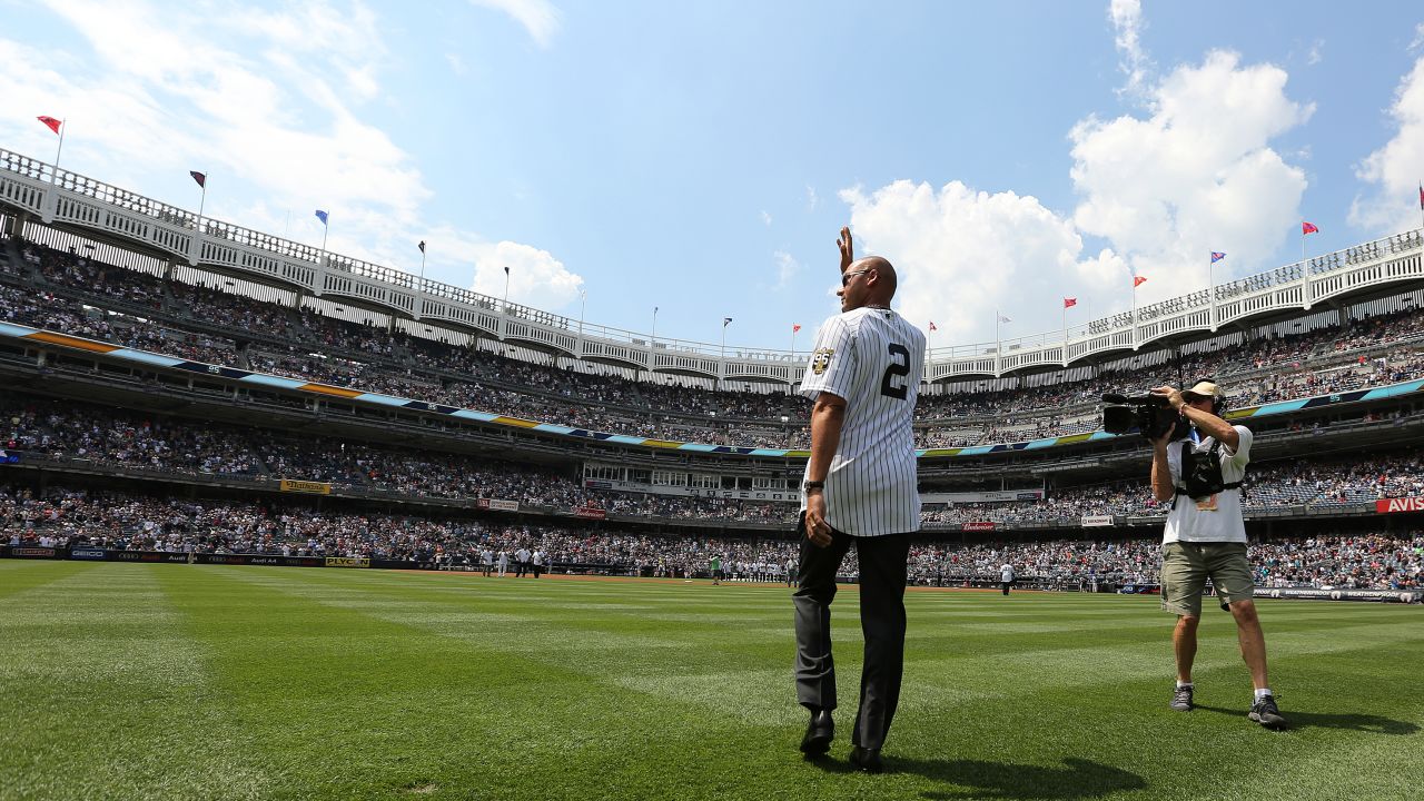 Jeter waves as he is introduced during a ceremony honoring the '96 Yankee championship.