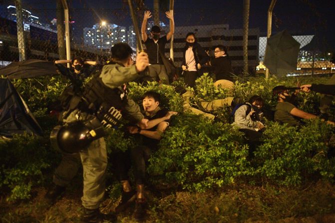 Police detain protesters and students outside Hong Kong Polytechnic University on Tuesday, November 19. Thousands of student protesters <a href="https://www.cnn.com/interactive/2019/11/world/hong-kong-campus-protests-cnnphotos/index.html" target="_blank">occupied the campus</a> as the city's violent political unrest reached fever pitch. Once inside, <a href="https://www.cnn.com/2019/11/19/asia/hong-kong-polytechnic-university-scene-intl-hnk/index.html" target="_blank">they soon faced an impossible choice:</a> stay inside until supplies run out, or leave the university and risk getting tear gassed and arrested for rioting, a charge that can fetch a 10-year prison sentence.