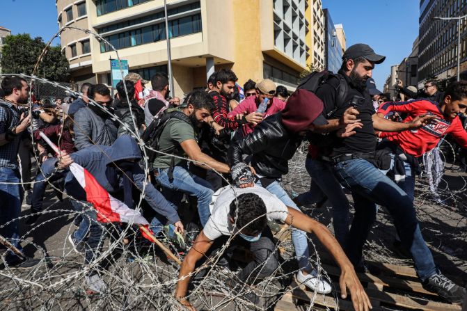Lebanese protesters flee from security forces in Beirut on Tuesday, November 19. <a href="https://www.cnn.com/2019/10/29/world/gallery/lebanon-protests-political-crisis-intl/index.html" target="_blank">Protesters have been filling the streets of Lebanon's urban centers</a> for around a month, frequently forcing road closures along the country's major routes. In recent months, Lebanon has seen rapid economic deterioration, ballooning debt and rising prices. Prime Minister Saad Hariri announced in October that he was resigning.