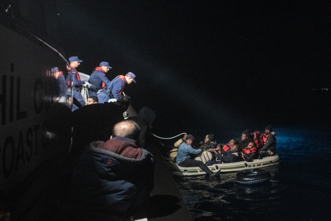 Migrants are seen on an inflatable boat Friday, November 15, as they are rescued by the Turkish Coast Guard on the Aegean Sea.