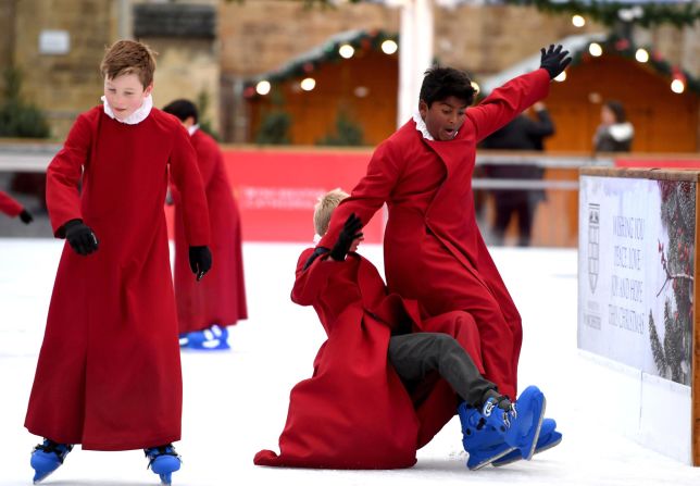 Choristers ice skate near the Winchester Cathedral in Winchester, England, on Wednesday, November 20.