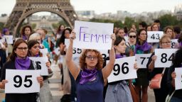 A person holds a placard reading "Woman" as people gather on the Trocadero square in front of the Eiffel tower in Paris during a demonstration called by the "Nous Toutes" feminist organisation to denounce the 100th feminicide of the year, on September 1, 2019. - For the year 2018, the Ministry of the Interior had identified 121 feminicides. (Photo by Zakaria ABDELKAFI / AFP)        (Photo credit should read ZAKARIA ABDELKAFI/AFP via Getty Images)