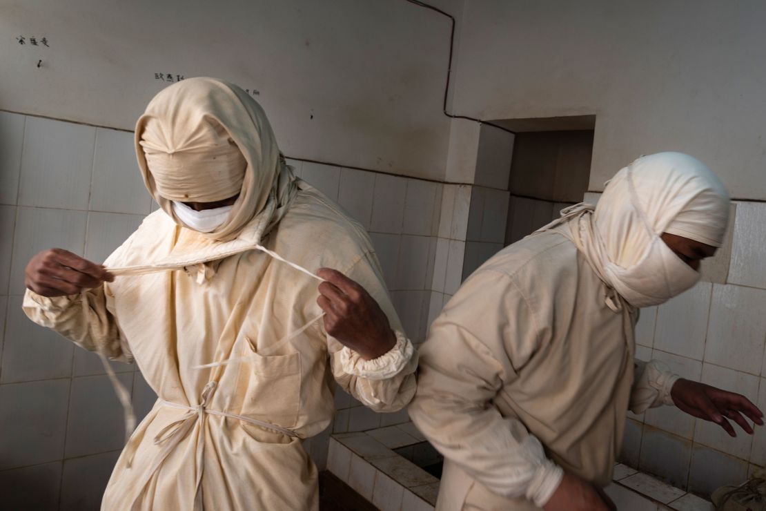 Staff members from a local disease control center wear prevention clothes and masks before entering a plague surveillance lab in Sichuan Province of China in August 28, 2019.