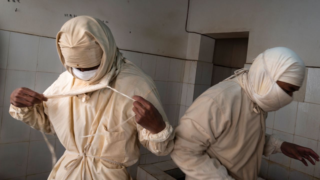 Staff members from a local disease control center wear prevention clothes and masks before entering a plague surveillance lab in Sichuan Province of China in August 28, 2019. 