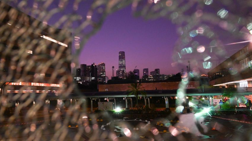The ICC (International Commerce Centre) is seen in the distance through glass damaged by protesters who barricaded themselves inside the Hong Kong Polytechnic University, in the Hung Hom district of Hong Kong on November 21, 2019. - A dwindling core of hardline protesters held their ground November 21 at a Hong Kong university besieged for days by police, as the US passed a bill lauding the city's pro-democracy movement, setting up a likely clash between Washington and Beijing. (Photo by Ye Aung THU / AFP) (Photo by YE AUNG THU/AFP via Getty Images)