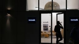 People exit the WeWork Cos. 32nd Milestone co-working space at night in Gurugram, India, on Monday, Feb. 18, 2019. The New York-based co-working giant WeWork Cos, which operates shared office spaces around the world, has attracted huge piles of investor money, which it uses to snap up office space in the largest cities on earth. Photographer: Ruhani Kaur/Bloomberg via Getty Images