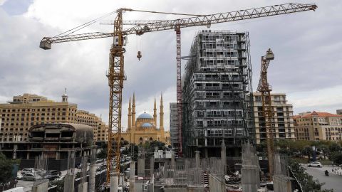 This picture taken on November 26, 2018 shows a view of a halted construction site and another still under construction in the downtown district of the Lebanese capital Beirut, with the city's landmark Mohammad al-Amin mosque seen in the background.