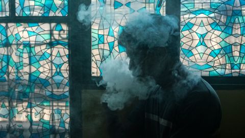 This photo illustration shows a customer smoking at a vape store in Manila on November 20, 2019. - Just hours after Philippine President Rodrigo Duterte announced he would ban e-cigarette use, police were ordered on November 20 to begin arresting people caught vaping in public and to confiscate the devices. (Photo by DANTE DIOSINA JR / AFP) (Photo by DANTE DIOSINA JR/AFP via Getty Images)