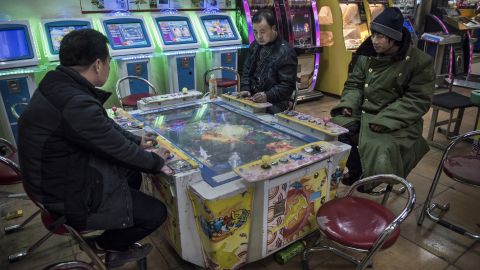 Chinese men play video games at an arcade on January 20, 2015 in central Beijing.