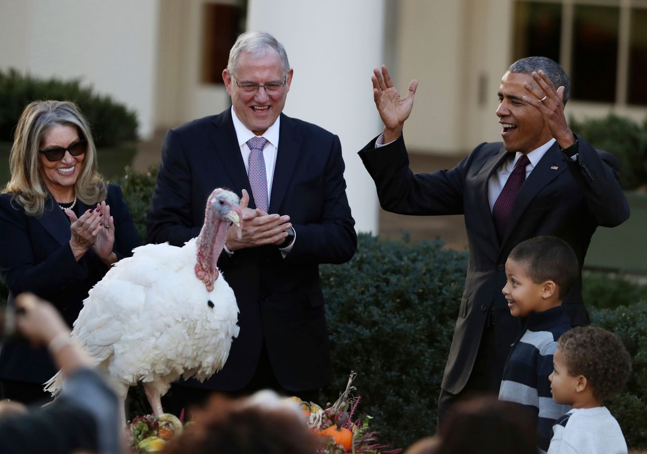 President Barack Obama, with his nephews Aaron and Austin Robinson, pardons Tot the turkey in 2016.