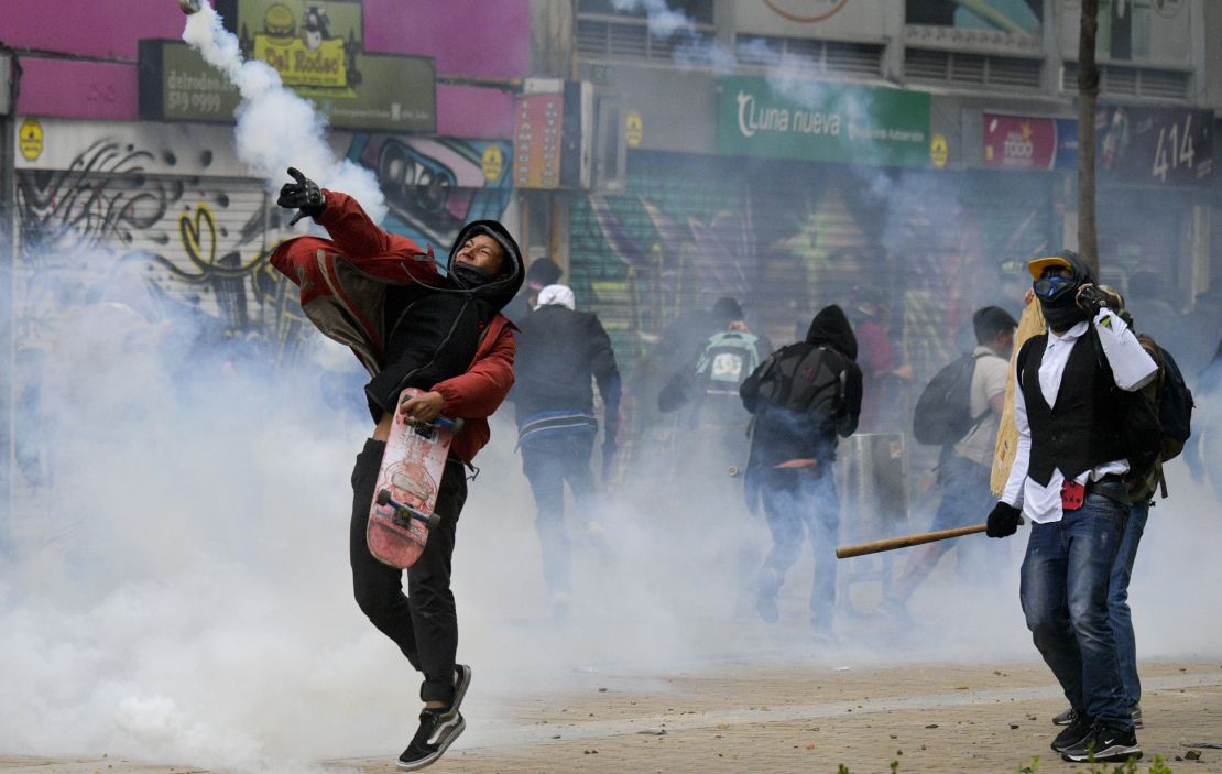 Demonstrators clash with riot police during a protest in Bogota.