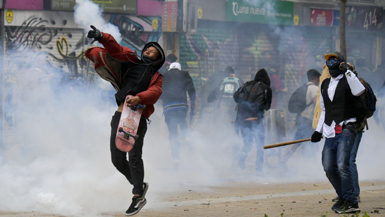 Demonstrators clash with riot police during a protest in Bogota.