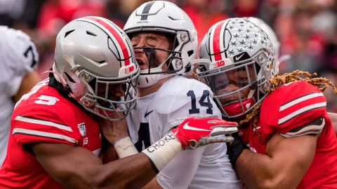 Penn State Nittany Lions quarterback Sean Clifford is sacked by Ohio State Buckeyes defensive end Chase Young linebacker Baron Browning. 