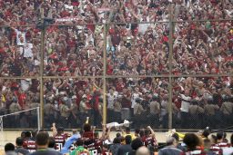 Players of Brazil's Flamengo celebrate with the trophy in front of their fans after winning the Copa Libertadores final by defeating Argentina's River Plate.