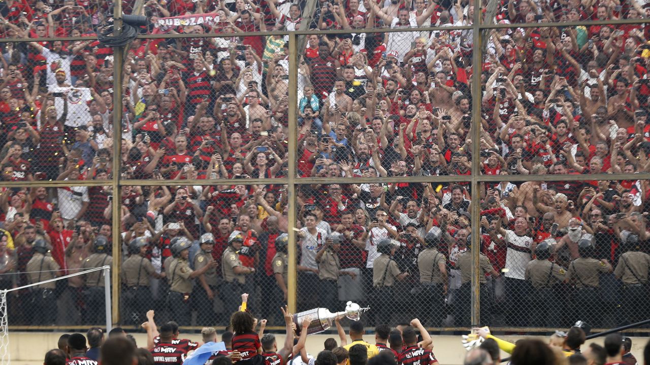 Players of Brazil's Flamengo celebrate with the trophy in front of their fans after winning the Copa Libertadores final by defeating Argentina's River Plate.