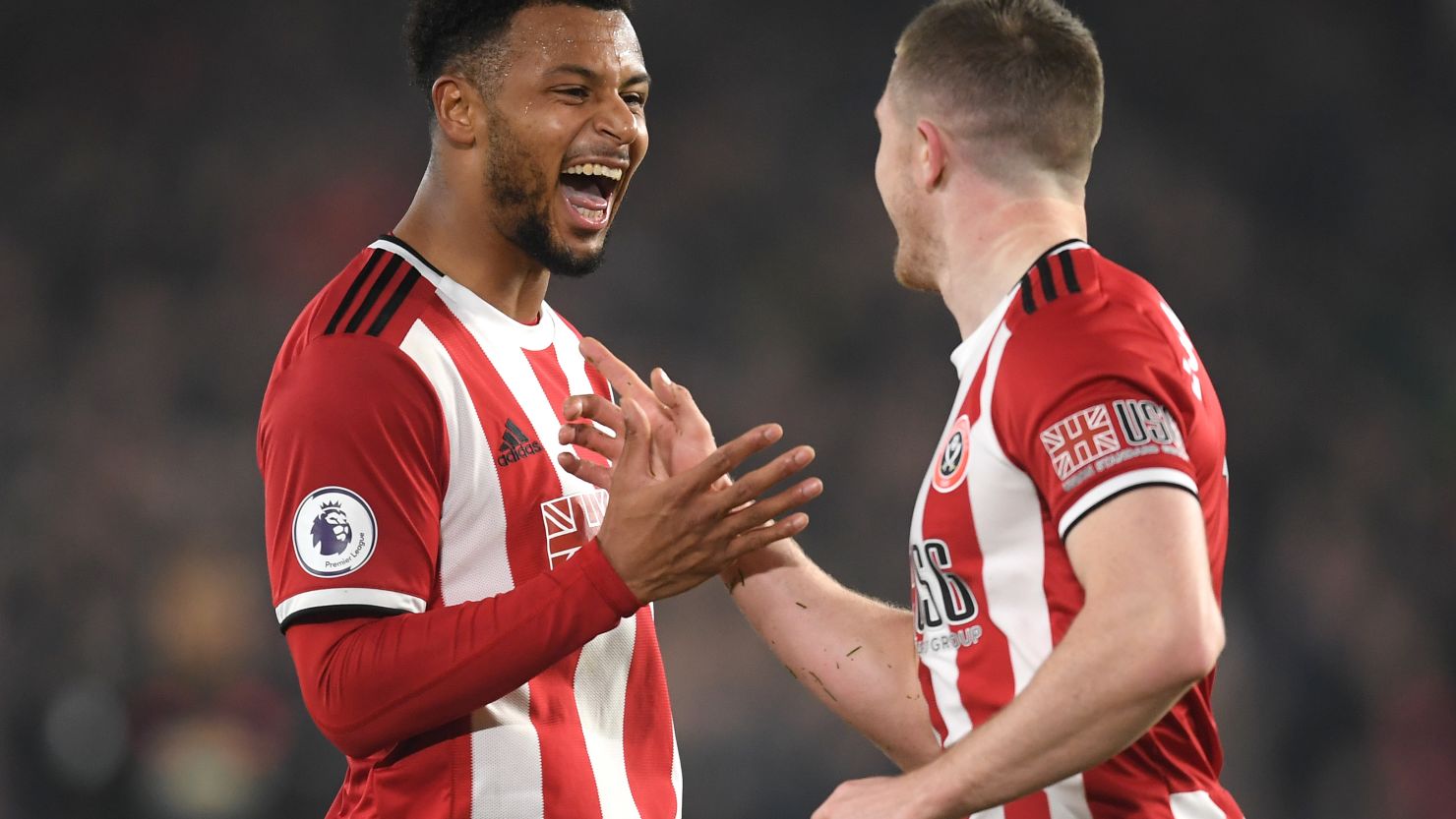 Lys Mousset celebrates with John Lundstram after scoring Sheffield United's second goal.