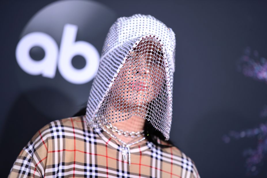 Billie Eilish paired a baggy Burberry outfit with a sparkly headpiece. 