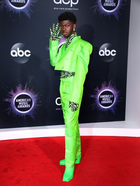 Lil Nas X turned heads in a neon green suit and an equally fluorescent zebra-print shirt. 