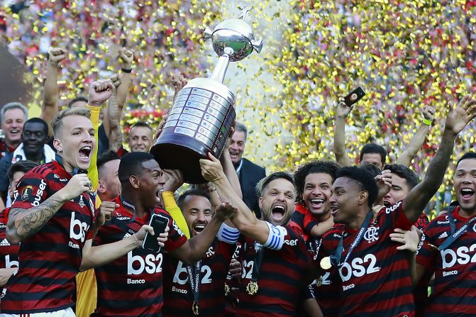Diego Alves, Everton Ribeiro and Diego of Flamengo celebrate with the team after winning the final match of Copa Conmebol Libertadores against River Plate at Estadio Monumental in Lima, Peru, on Saturday, November 23. 