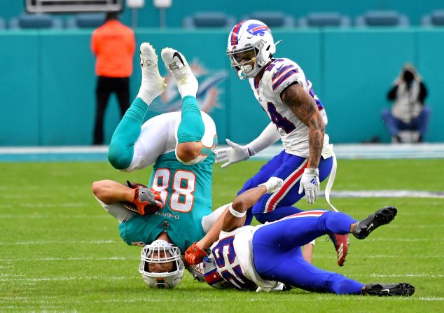 Miami tight end Mike Gesicki is upended by Buffalo's Kevin Johnson during an NFL game on Sunday, November 17.
