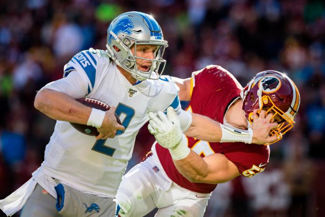 Detroit Lions Jeff Driskel stiff-arms Cole Holcomb of the Washington Redskins during the first half in Landover, Maryland, on Sunday, November 24. 