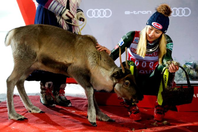 Mikaela Shiffrin of USA feeds a reindeer during the Audi FIS Alpine Ski World Cup Women's Slalom on Saturday, November 23, in Levi, Finland. 