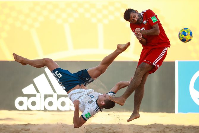 Boris Nikonorov of Russia struggles for the ball with Haitham Mohamed of United Arab Emirates during the FIFA Beach Soccer World Cup Paraguay 2019 group C match on Sunday, November 24 in Asuncion, Paraguay. 