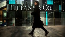 In this Thursday, Nov. 29, 2018, photo, a woman walks past a Tiffany & Co. store at a shopping mall in Beijing.