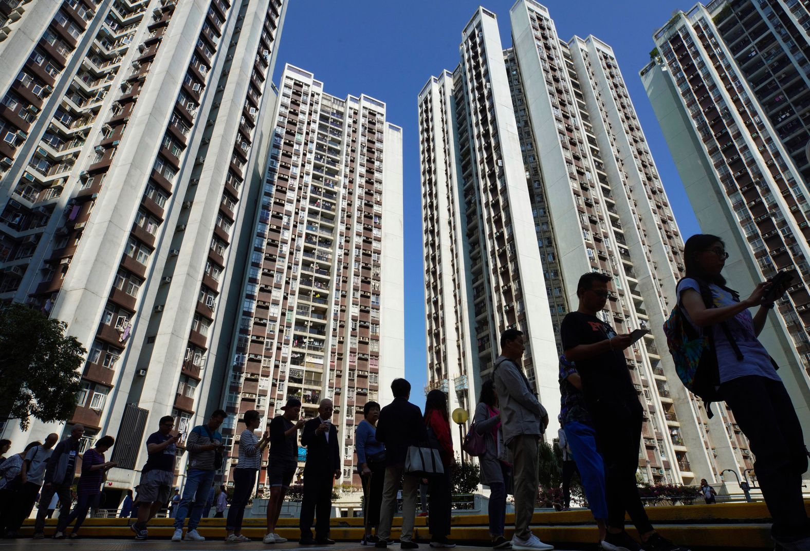 People line up to vote outside of a polling place in Hong Kong, November 24. More than <a href="index.php?page=&url=https%3A%2F%2Fwww.cnn.com%2F2019%2F11%2F24%2Fasia%2Fhong-kong-district-council-elections-intl%2Findex.html" target="_blank">2.9 million people turned out</a> to vote in Sunday's elections, which have been framed as a <a href="index.php?page=&url=https%3A%2F%2Fwww.cnn.com%2F2019%2F11%2F22%2Fasia%2Fhong-kong-protests-district-council-elections-intl-hnk%2Findex.html" target="_blank">de facto referendum</a> on the almost six months of ongoing protests.