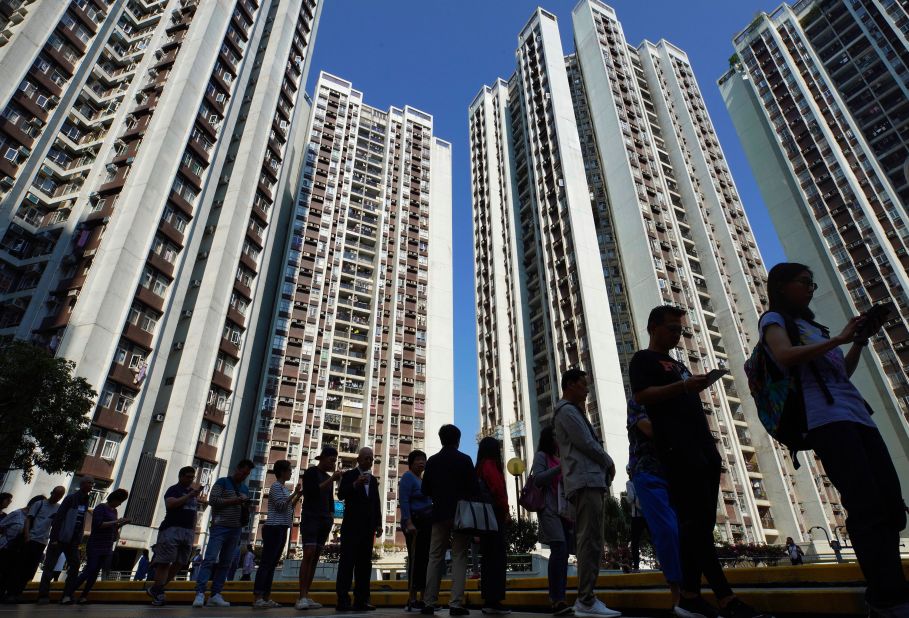 People line up to vote outside of a polling place in Hong Kong, November 24. More than <a href="https://www.cnn.com/2019/11/24/asia/hong-kong-district-council-elections-intl/index.html" target="_blank">2.9 million people turned out</a> to vote in Sunday's elections, which have been framed as a <a href="https://www.cnn.com/2019/11/22/asia/hong-kong-protests-district-council-elections-intl-hnk/index.html" target="_blank">de facto referendum</a> on the almost six months of ongoing protests.