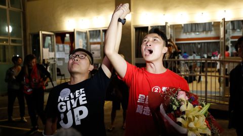 Pro-democracy candidate Jimmy Sham, right, celebrates with a supporter after winning his election in the Sha Tin district, early November 25. 