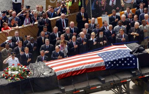 The last steel beam that was standing from one of the World Trade Center towers is driven past Bloomberg and other dignitaries in May 2002. The ceremony marked the end of the recovery and cleanup efforts and the start of reconstruction.