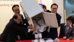 HONG KONG, CHINA - NOVEMBER 24: Barnabus Fung (2nd R) and Patrick Nip Tak-kuen (2nd L) empty a ballot box to count votes at a polling station on November 24, 2019 in Hong Kong, China. Hong Kong held its district council election on Sunday as anti-government protests continue into a sixth month, with demands for an independent inquiry into police brutality, the retraction of the word "riot" to describe the rallies, and genuine universal suffrage. (Photo by Billy H.C. Kwok/Getty Images)