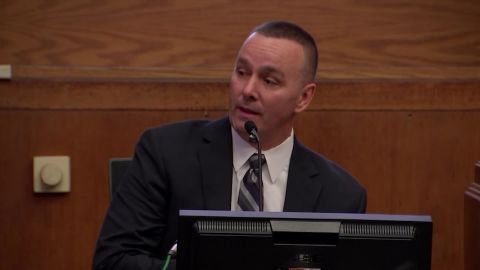 Boston police detective Sean Wallace testified he saw Bampumim Teixeira, charged with killing two Boston doctors, smiling up at him as he was being arrested