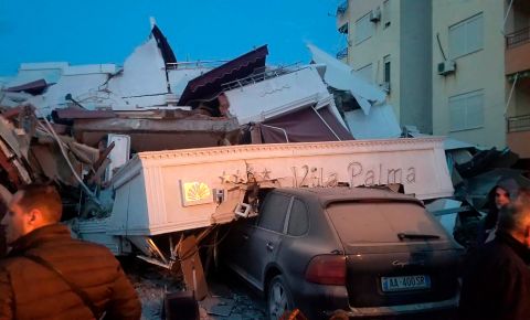 A car is buried beneath debris at a hotel in Durres.