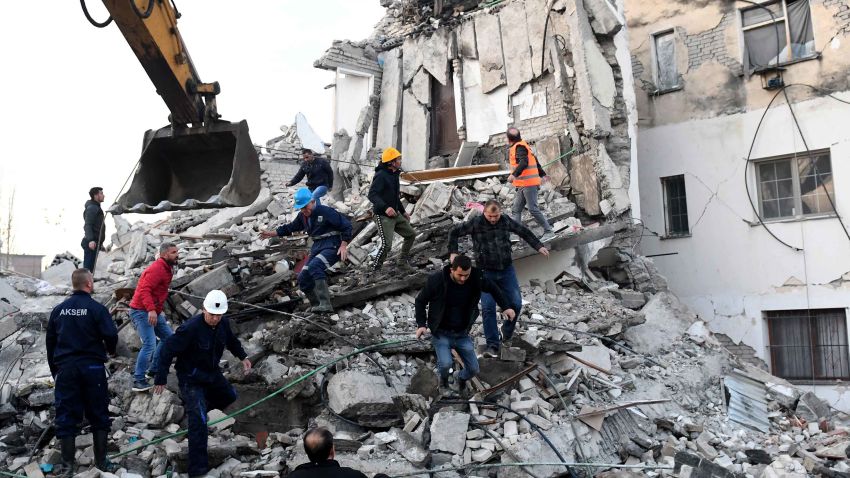 TOPSHOT - Emergency workers clear debris at a damaged building in Thumane, 34 kilometres (about 20 miles) northwest of capital Tirana, after an earthquake hit Albania, on November 26, 2019. - Four people died and some 150 were slightly injured in Albania after a 6.4 magnitude earthquake, the strongest in decades, rocked the Balkan country early Tuesday. The epicentre of the quake was about 34 kilometres (about 20 miles) northwest of Tirana, according to the European-Mediterranean Seismological Centre. (Photo by Gent SHKULLAKU / AFP) (Photo by GENT SHKULLAKU/AFP via Getty Images)