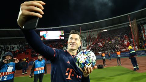 Robert Lewandowski takes a selfie with his match ball after scoring his third hat trick of the season.