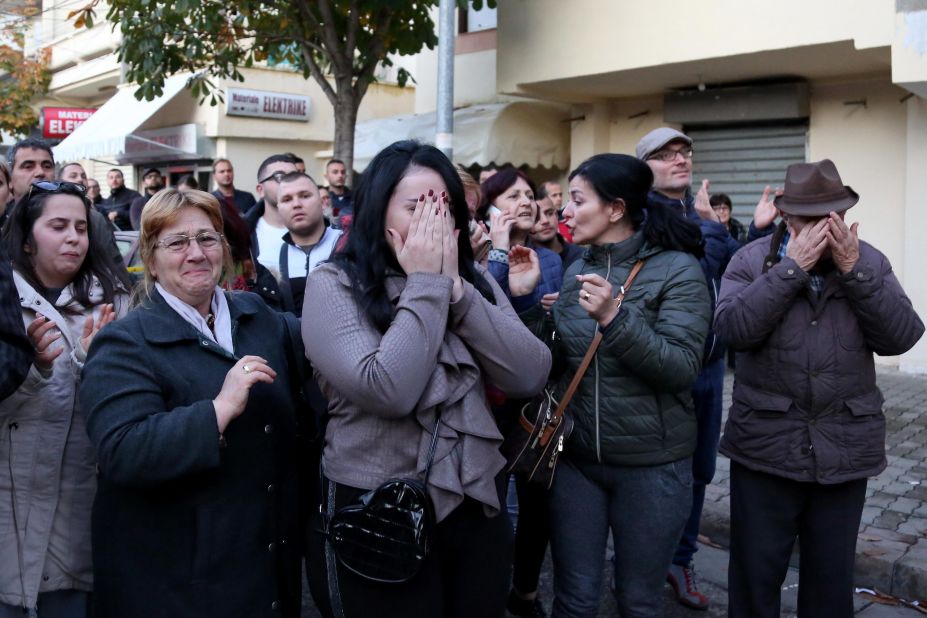 People grieve at the site of the disaster in Durres.