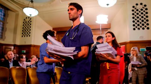 NHS workers hand out documents on the Conservative government's UK-US trade talks during a a press conference by the opposition Labour party leader Jeremy Corbyn.