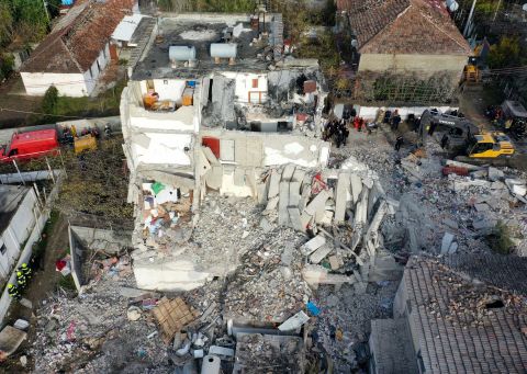 An aerial photo taken on Wednesday, November 27, shows emergency crews searching the rubble of a collapsed building in Thumane, Albania, the day after a devastating earthquake struck the region. 