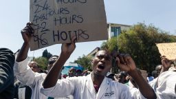 Doctors and medical staff march to Zimbabwe's Parliament on September 19, 2019 in Harare with a petition demanding the safe return of Peter Magombeyi, a doctors' union leader who has been missing since September 14 at night, after he sent a WhatsApp message saying he had been "kidnapped by three men", according to the Zimbabwe Hospital Doctors Association (ZHDA). - Demonstrator believe he was taken because of his role in organising strikes to demand better pay and working conditions. Doctors are paid less than $200 (180 euros) per month in Zimbabwe, a country still struggling with hyperinflation and fuel and food shortages after decades of economic crisis under former president, who died a week ago. (Photo by Jekesai NJIKIZANA / AFP)        (Photo credit should read JEKESAI NJIKIZANA/AFP via Getty Images)
