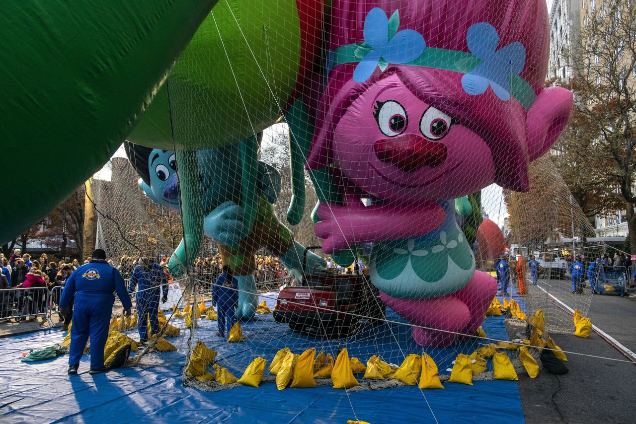 The Trolls balloon is kept under a net during the inflation process.