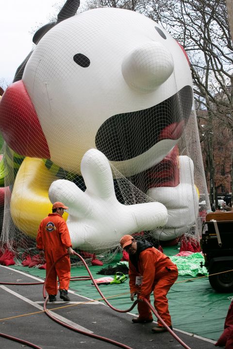 Workers carry a helium hose as the "Diary of a Wimpy Kid" balloon is inflated.