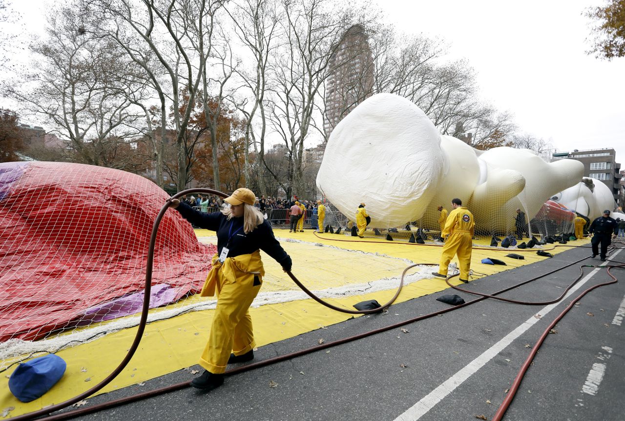 Workers inflate the Pillsbury Doughboy balloon.