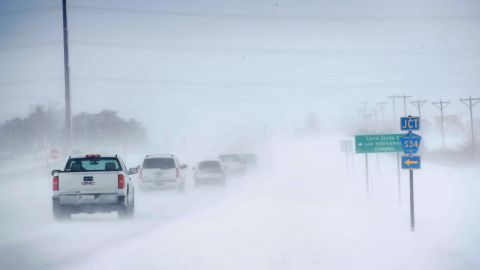 Motorists navigate an ice and snow-covered road in Mason City, Iowa.